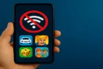 Hand holding a smartphone showing no Wi-Fi symbol with mobile game icons on the screen